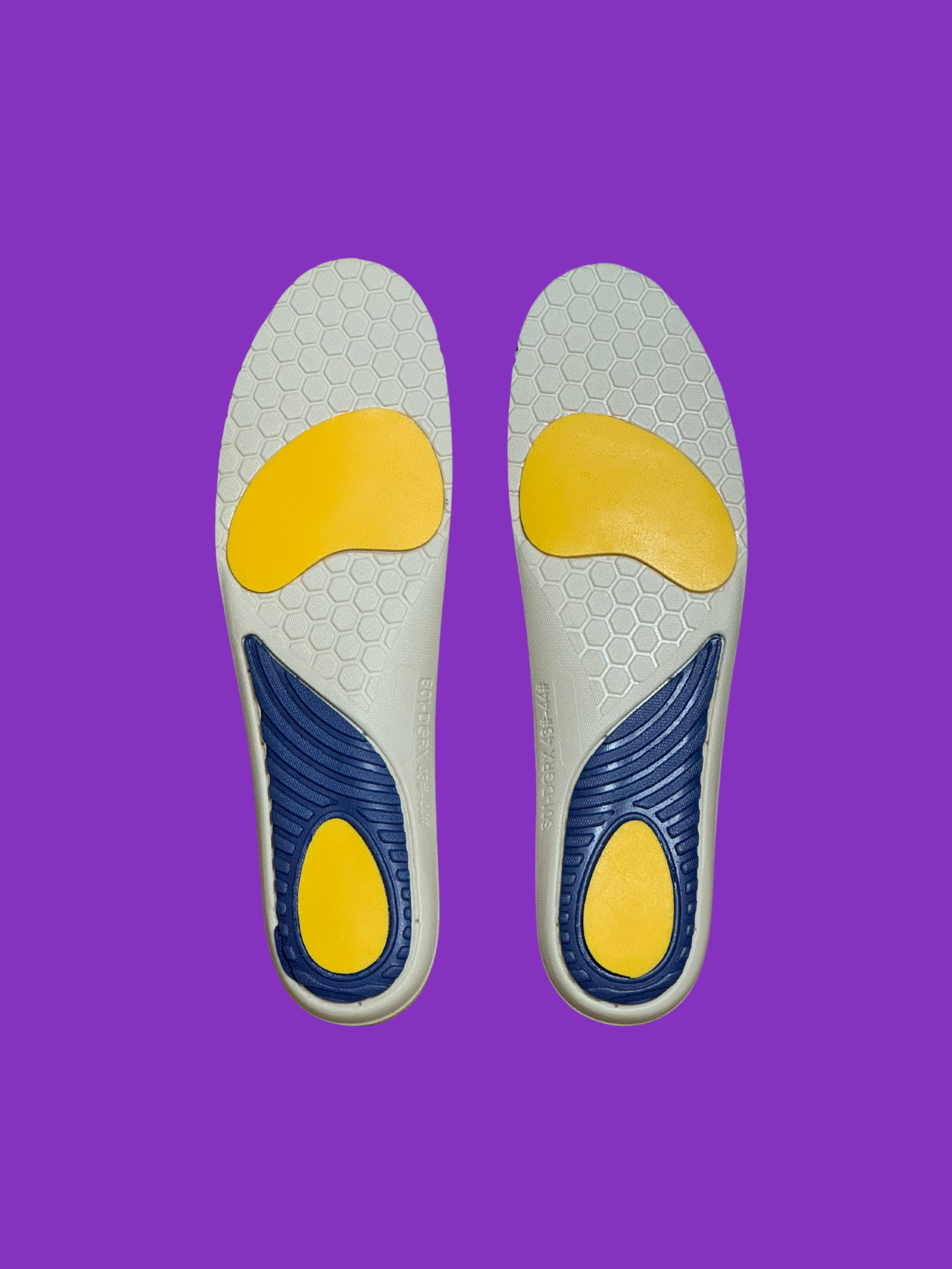 Pair of health insoles with yellow and blue design on a purple background